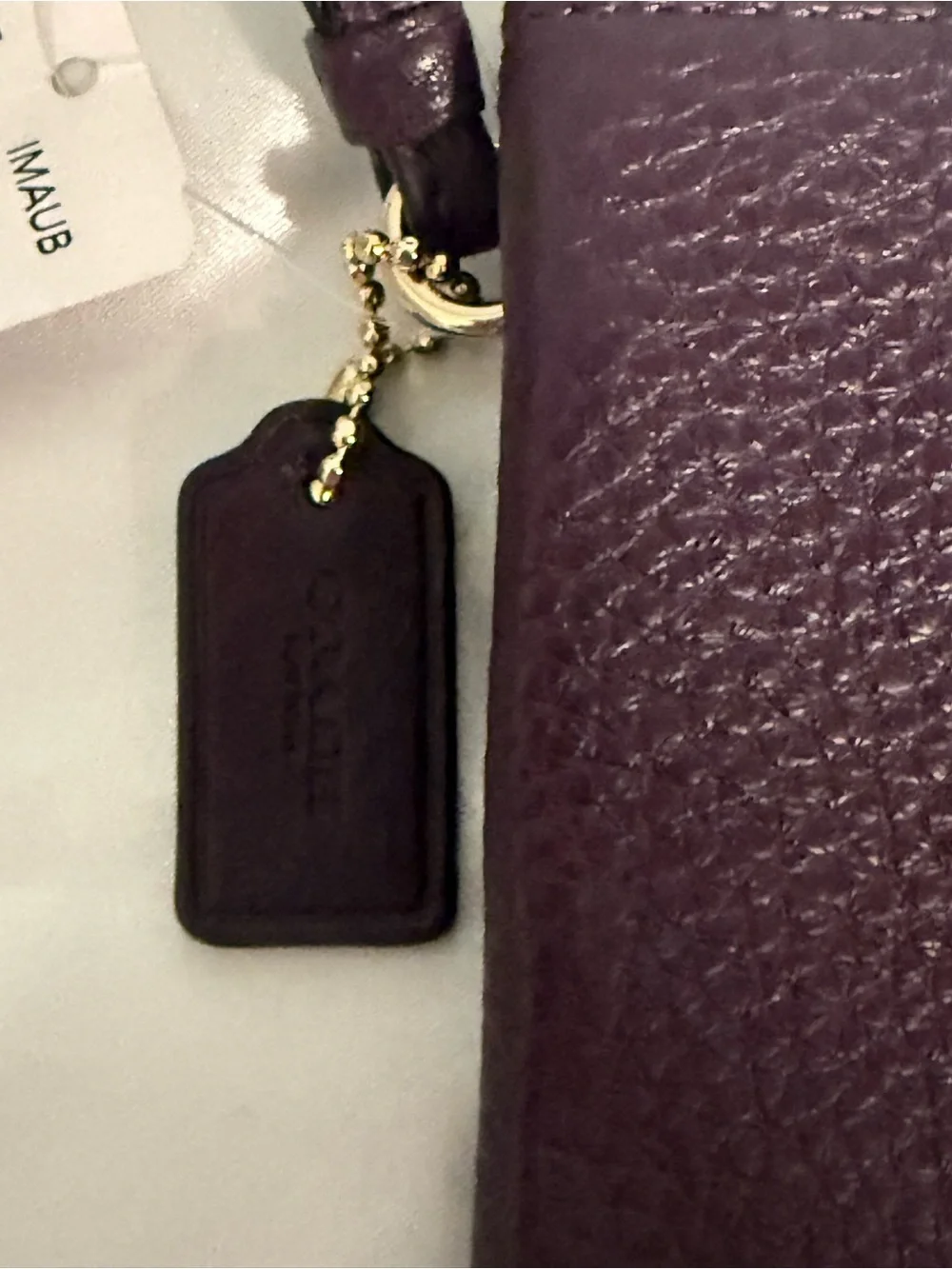 Coach NWT Pebbled Leather Wristlet in Plum w/handtag and two zip compartments.